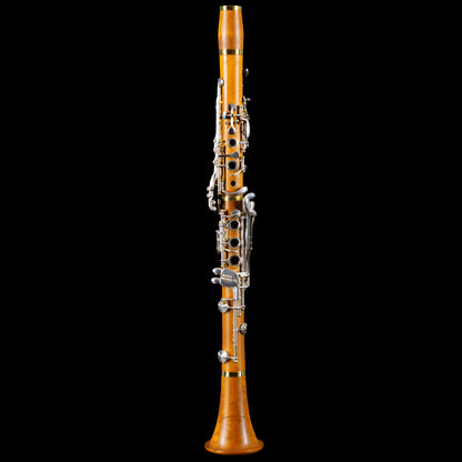 Boxwood clarinet with silver keys on black background
